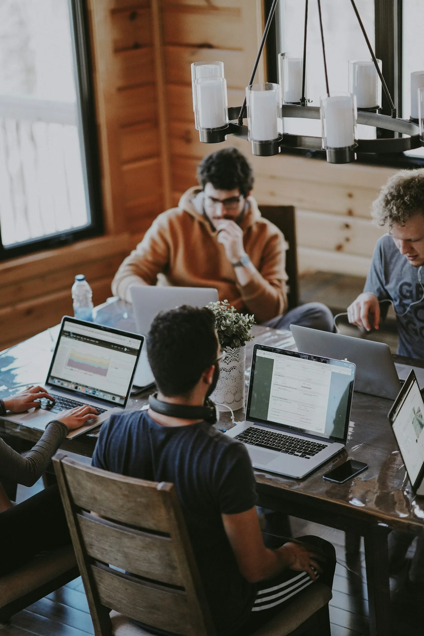 Technology professionals collaborating around a shared workspace